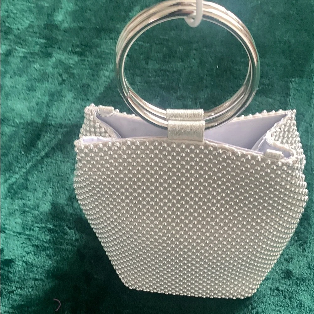 NWOT Silver Wristlet. Metal Handle & crossbody chain strap.